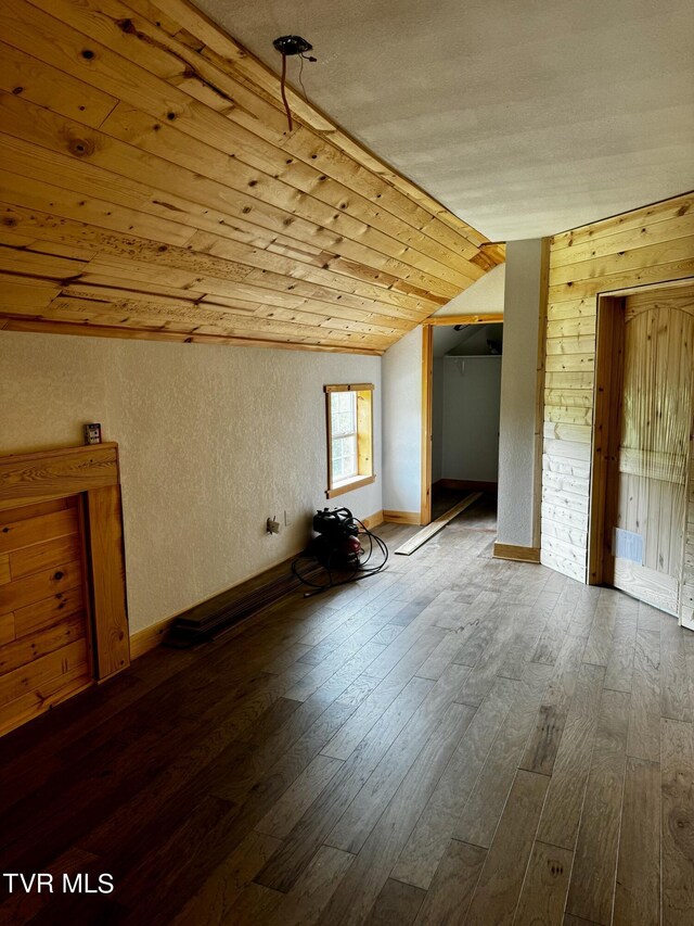 bonus room with wooden walls, vaulted ceiling, hardwood / wood-style floors, and wooden ceiling