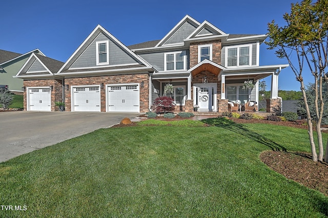 craftsman house featuring a porch, a garage, and a front yard