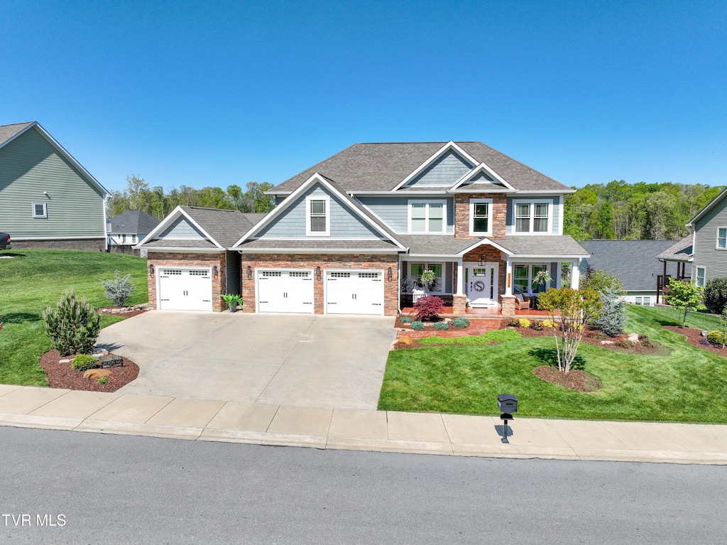 view of front of house featuring a garage and a front yard