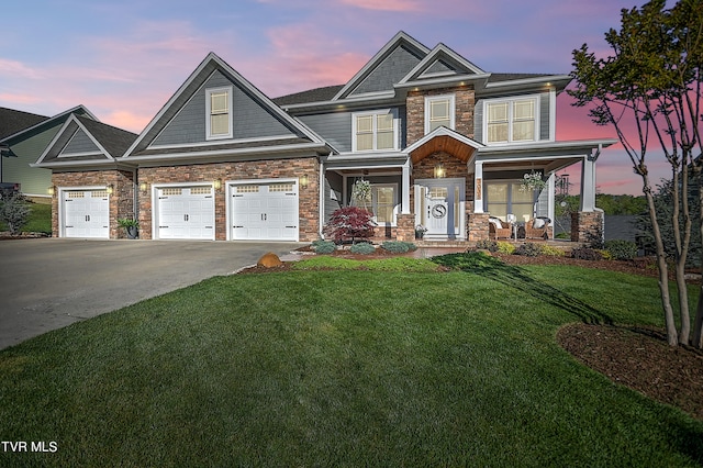 craftsman-style home featuring a lawn and a garage