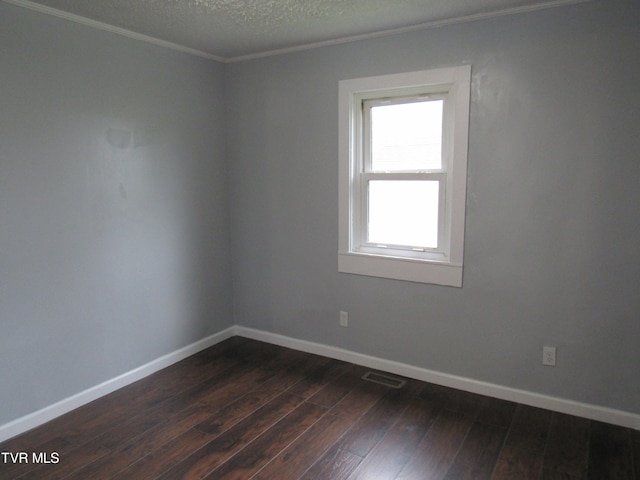 empty room featuring wood-type flooring and a textured ceiling