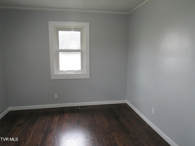 spare room with ornamental molding and hardwood / wood-style floors