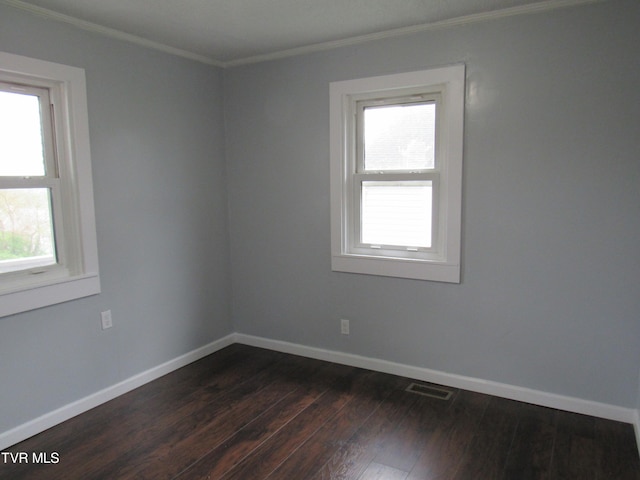 spare room featuring crown molding and wood-type flooring