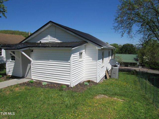 view of home's exterior with a lawn