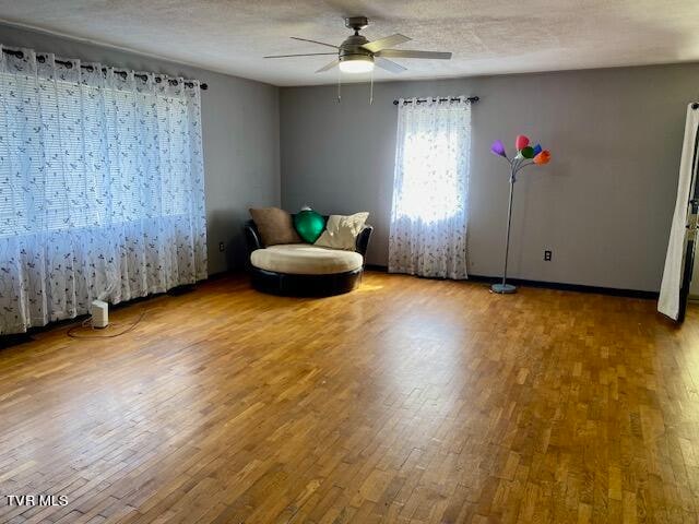 unfurnished room with ceiling fan and hardwood / wood-style flooring