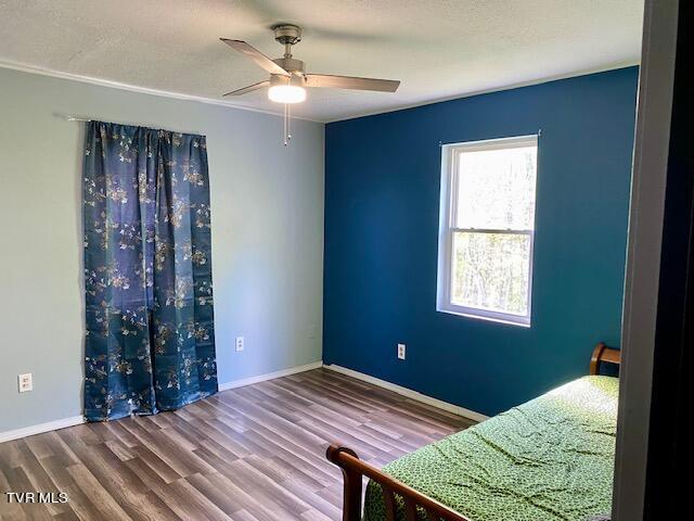 unfurnished bedroom with hardwood / wood-style flooring and ceiling fan