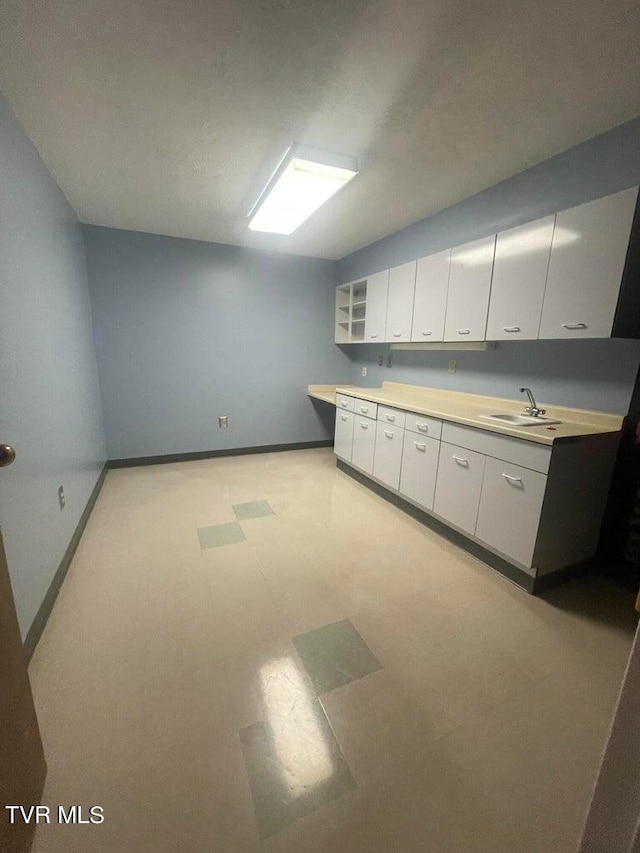 kitchen featuring white cabinets and sink