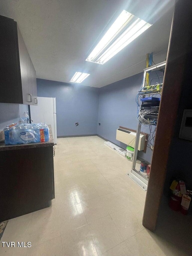 interior space featuring white fridge and light tile floors