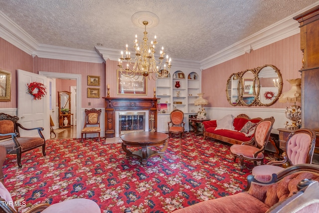 living room featuring built in features, a notable chandelier, crown molding, and a textured ceiling