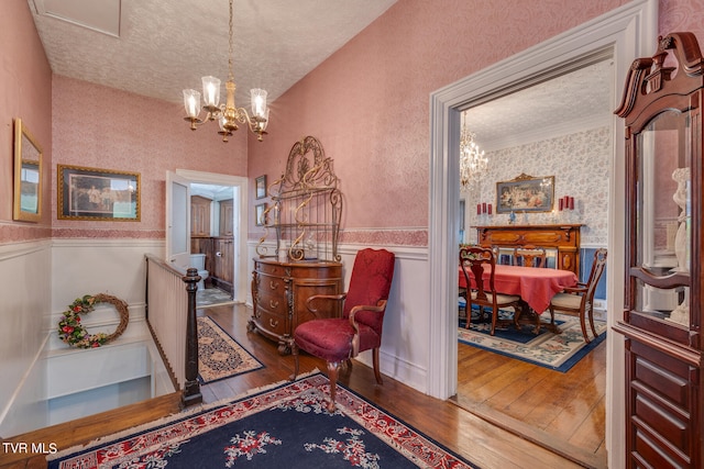 entryway featuring a textured ceiling, hardwood / wood-style floors, and a chandelier