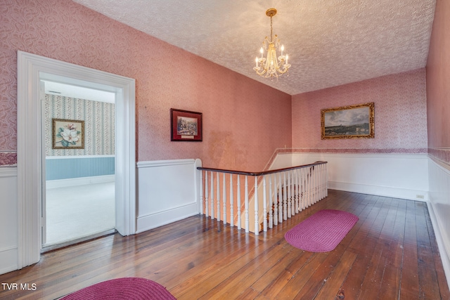 interior space featuring a textured ceiling, a chandelier, and carpet flooring