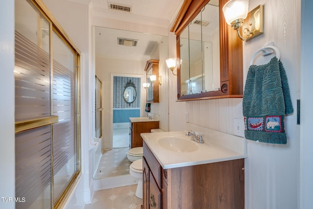 bathroom with tile flooring, oversized vanity, toilet, and a textured ceiling