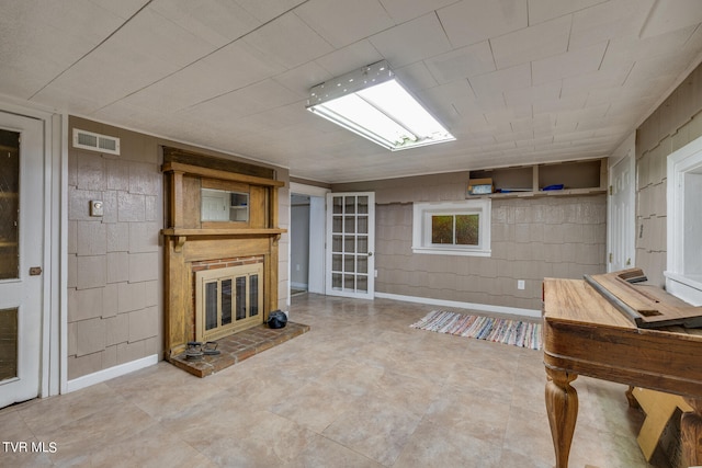 interior space with a fireplace and tile floors