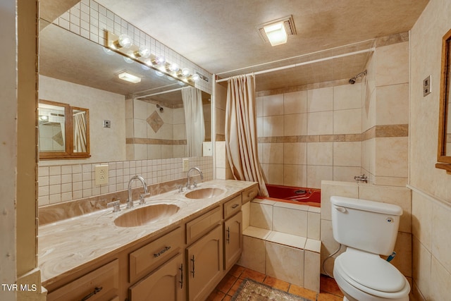 full bathroom featuring oversized vanity, tile walls, and toilet