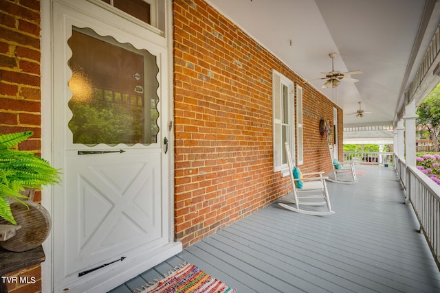 wooden terrace featuring ceiling fan