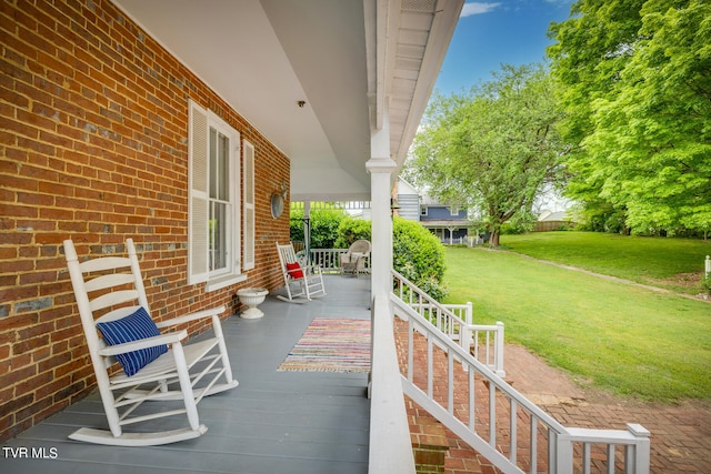 wooden terrace with a yard