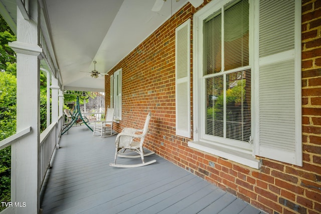 wooden deck featuring ceiling fan