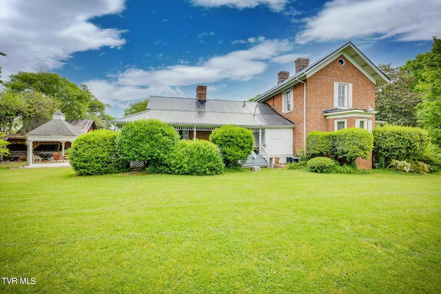 view of front facade featuring a gazebo and a front yard