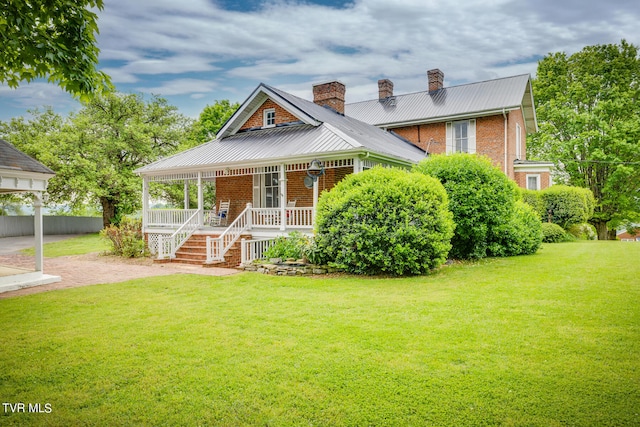 view of front of property with covered porch and a front yard