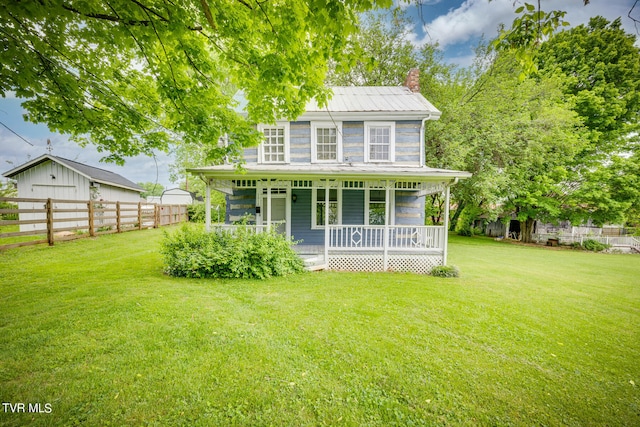 back of house featuring a porch and a lawn