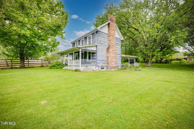 rear view of house featuring a lawn