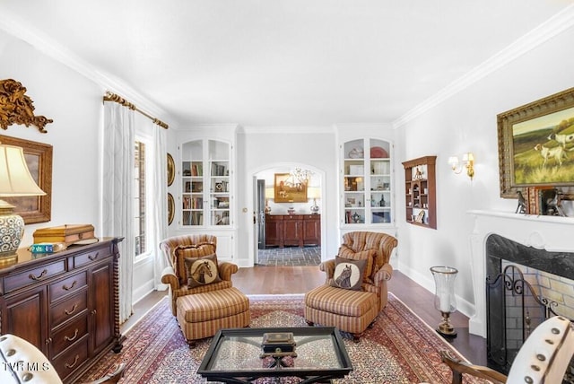 sitting room featuring ornamental molding and hardwood / wood-style flooring