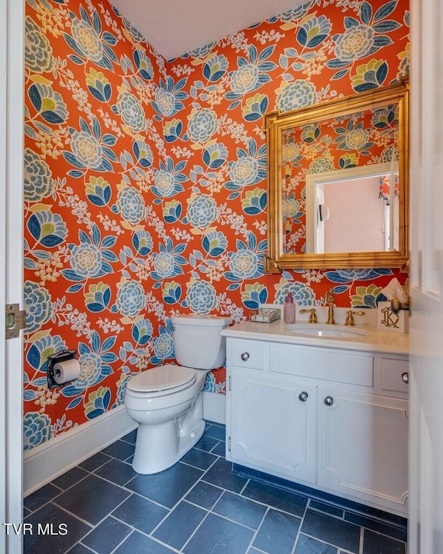 bathroom featuring vanity, toilet, and tile patterned flooring