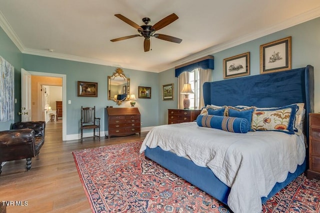 bedroom featuring crown molding, ceiling fan, and light hardwood / wood-style floors