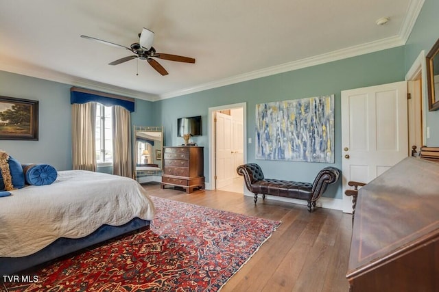 bedroom featuring ornamental molding, hardwood / wood-style floors, and ceiling fan