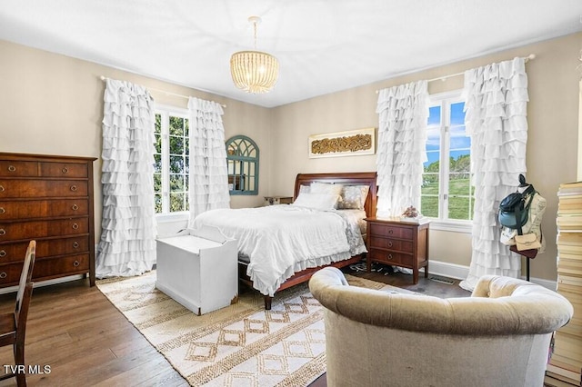 bedroom featuring a chandelier and hardwood / wood-style floors