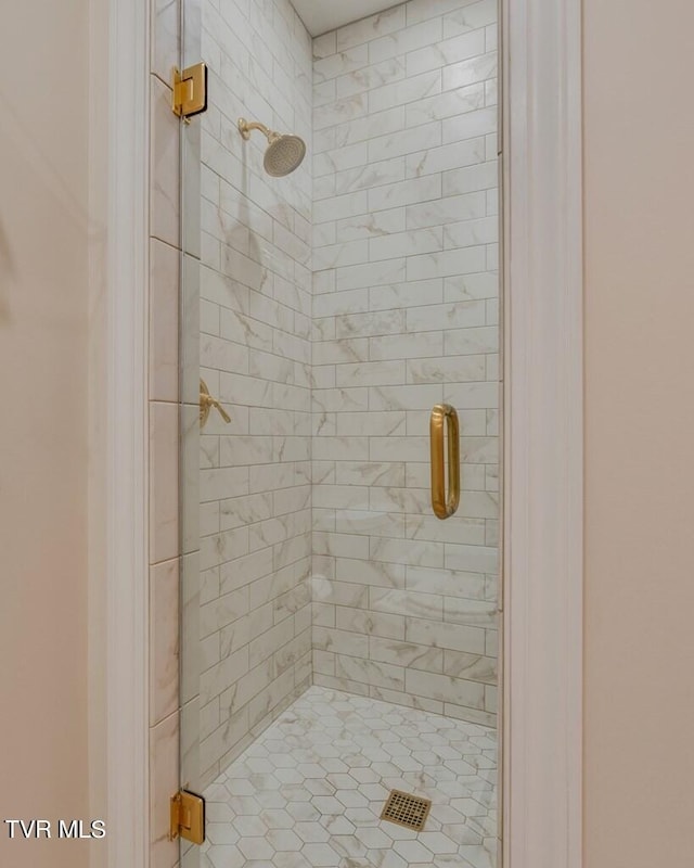 bathroom with tiled shower