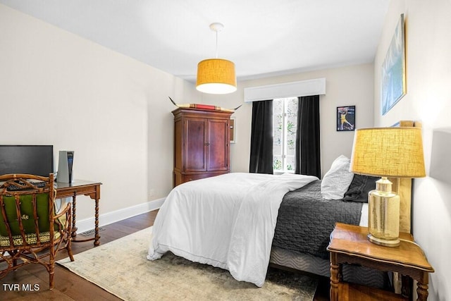 bedroom with dark wood-type flooring