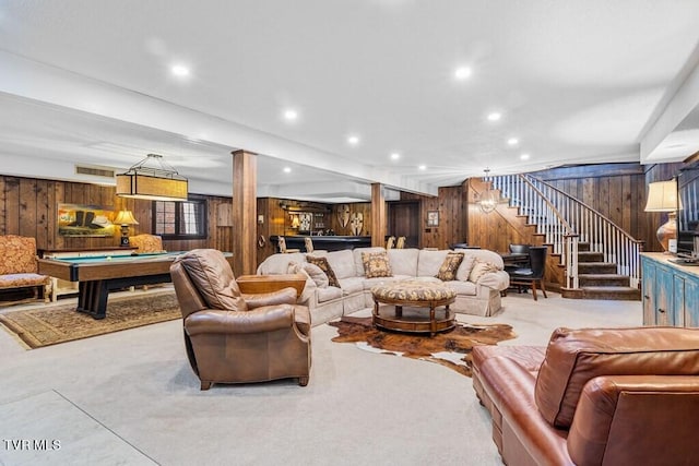 living room featuring wood walls and pool table