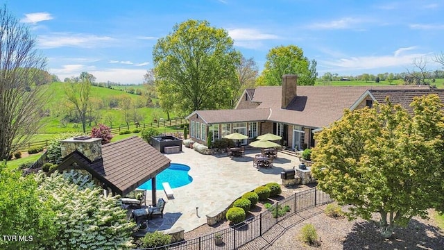 view of pool featuring a rural view and a patio area