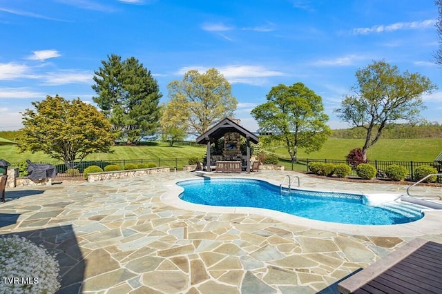 view of pool featuring a patio, a gazebo, and a yard