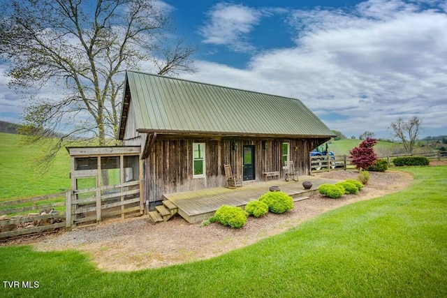 back of house with a lawn