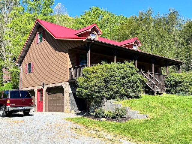 view of side of property featuring a yard and a garage