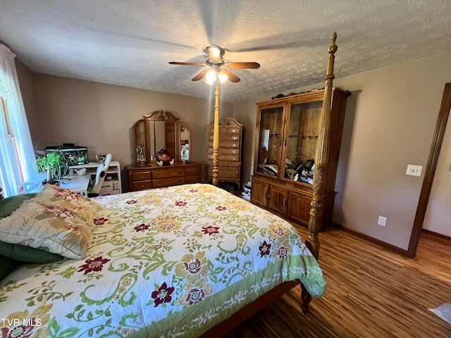 bedroom featuring wood-type flooring, ceiling fan, and a textured ceiling