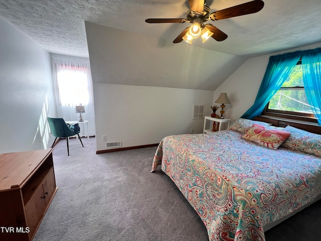 carpeted bedroom featuring vaulted ceiling, ceiling fan, and a textured ceiling