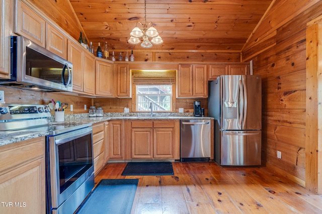 kitchen featuring light stone countertops, hardwood / wood-style floors, wood ceiling, lofted ceiling, and appliances with stainless steel finishes