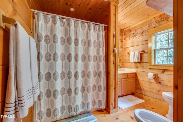 bathroom with toilet, wood ceiling, wood-type flooring, wooden walls, and vanity