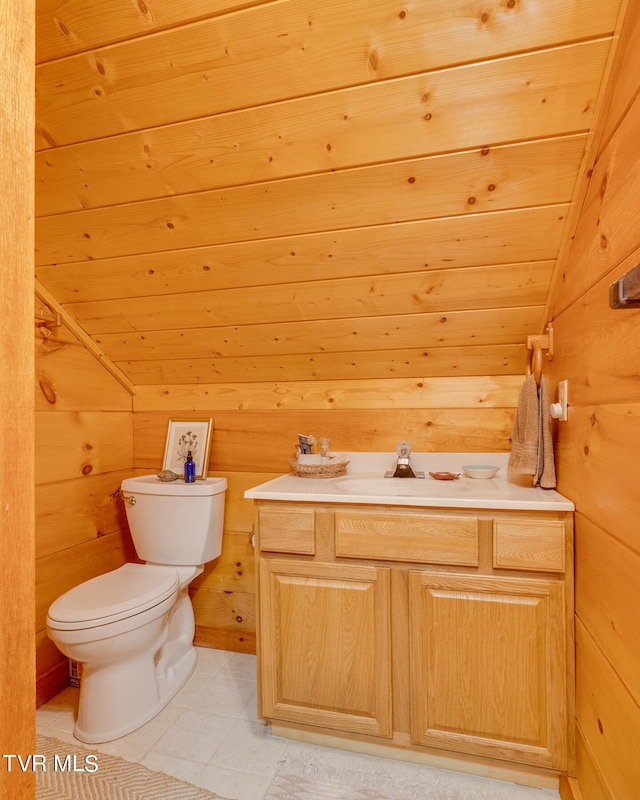 bathroom featuring lofted ceiling, wood walls, vanity, and toilet