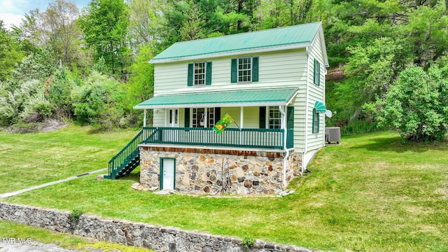 view of front of home featuring a porch, a front lawn, and central air condition unit