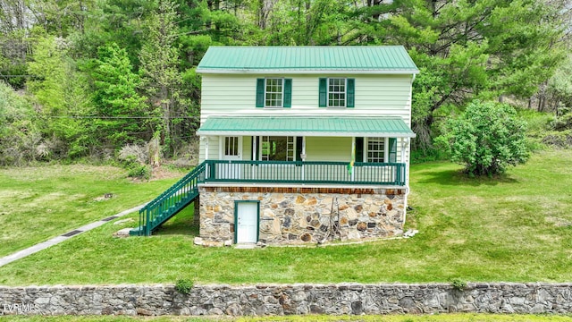 view of front of house featuring covered porch and a front lawn