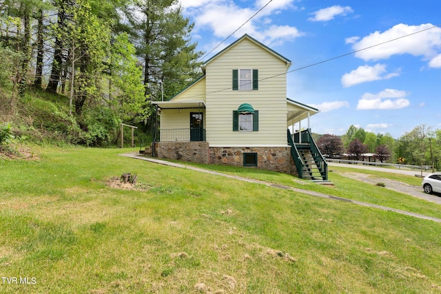 view of front of home featuring covered porch and a front yard