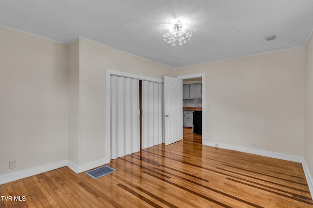 unfurnished bedroom with a closet and hardwood / wood-style flooring