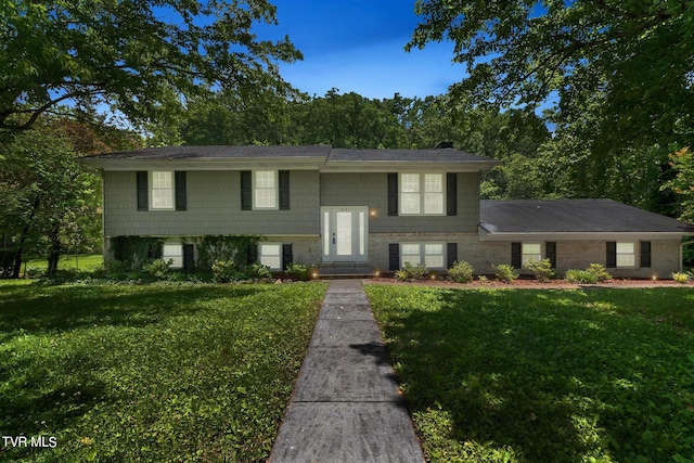 split foyer home with a front lawn