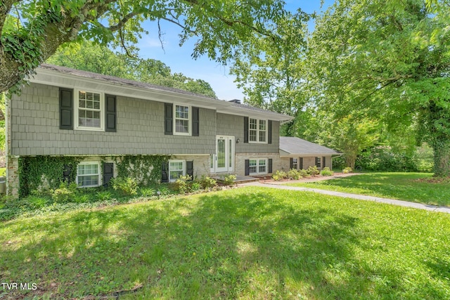 raised ranch with a front yard