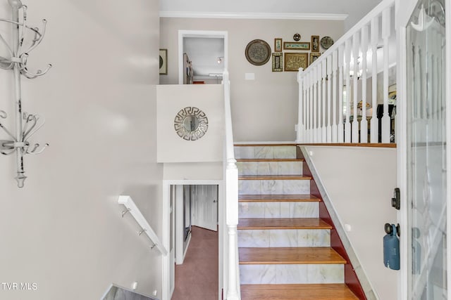 staircase with ornamental molding and hardwood / wood-style flooring