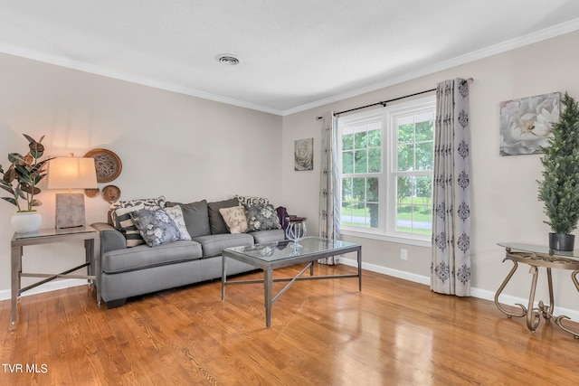 living room with crown molding and light wood-type flooring